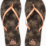 Reef Women's Bliss-Full Sandal - A pair of women's sandals with a floral pattern on a dark brown background, featuring light-colored flowers and leaves.