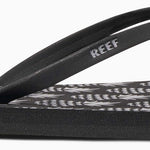 Reef Women's Bliss-Full Sandal 2020 - A pair of black sandals with a pink logo on the strap.