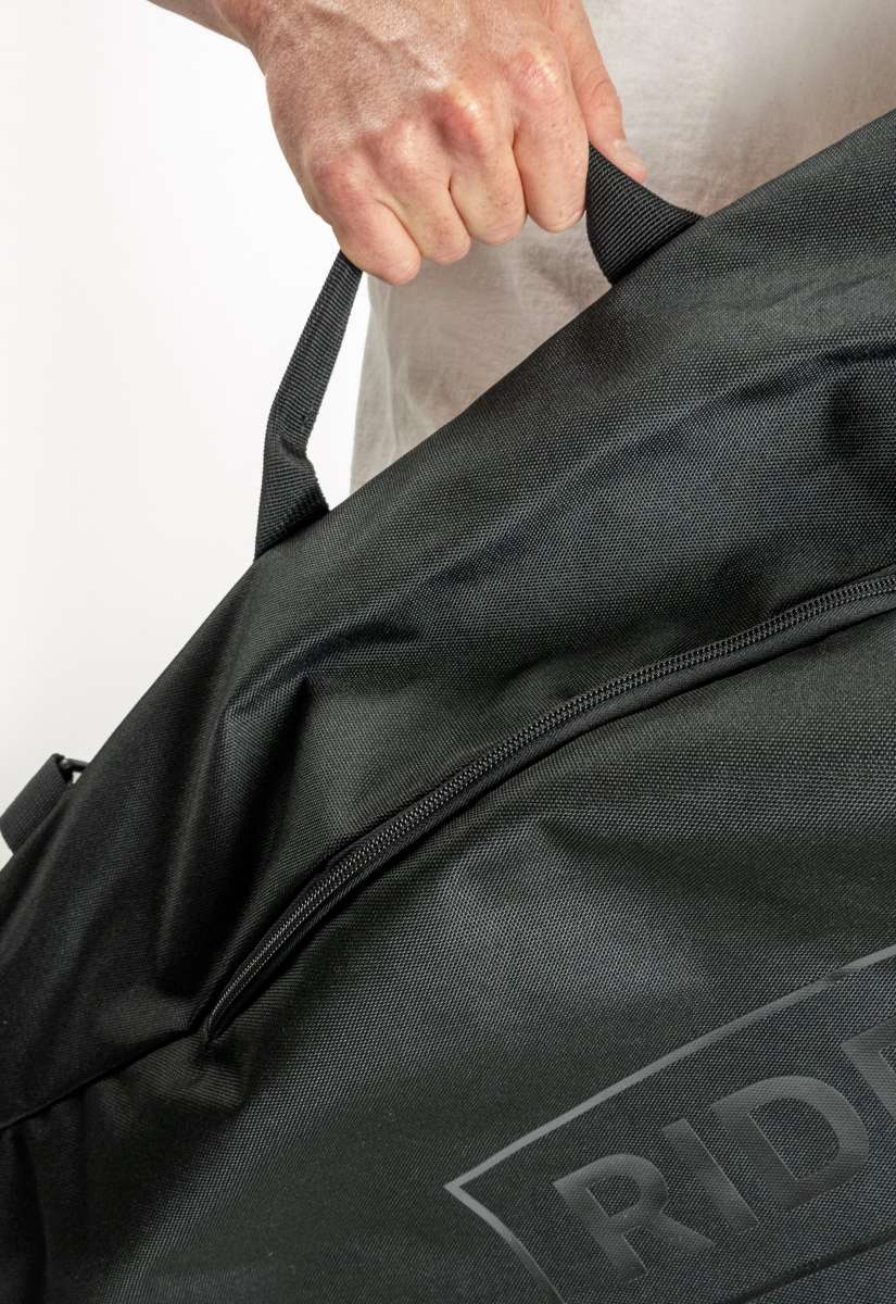 Ride Blackened Board Bag 2023 - A black duffel-style bag with a zippered top and two handles, featuring the word "RIDE" in white letters on one side.