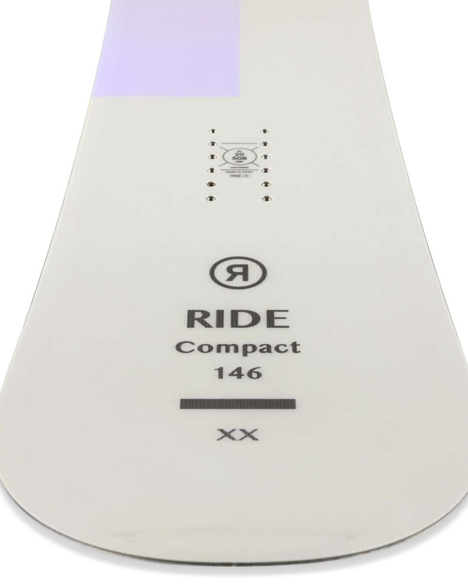 Ride Women's Compact Snowboard 2023 - A white snowboard with a purple stripe at the top.