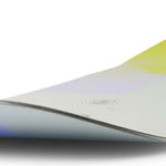 Ride Women's Compact Snowboard 2023 - A snowboard with a light purple top and yellow bottom, featuring a subtle white pattern on its surface.