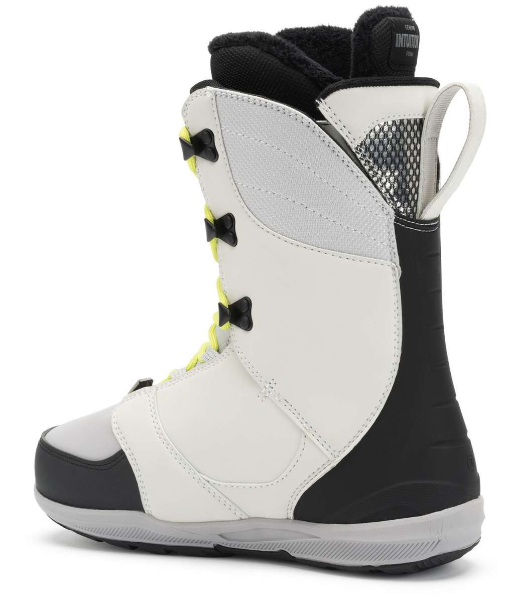 Ride Ladies Context Snowboard Boot 2022 - A white snowboard boot with black accents and yellow laces, featuring a textured pattern on the side.