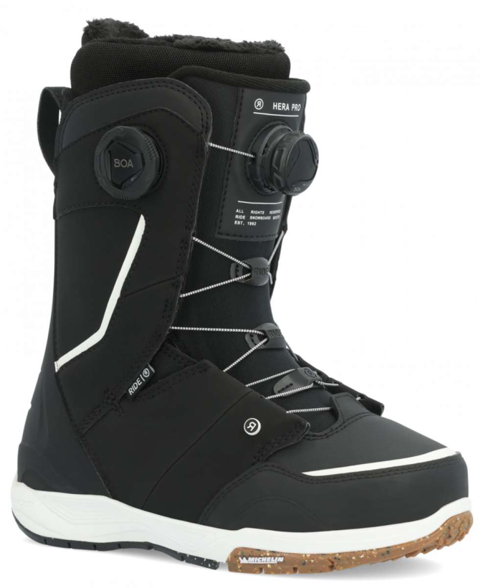 Ride Women's Hera Pro Snowboard Boot 2024 - Black snowboard boots with white accents and a brown sole.