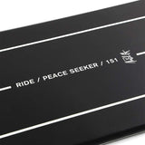 Ride - Peace Seeker Snowboard 2023 is shown in a dark gray color with white lettering and graphics on the top sheet.
