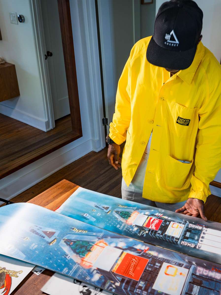 Ride Russell X Algoryhythm LTD Snowboard 2024 - A snowboard with a predominantly white base and blue accents, featuring a distinctive "Algorythym" logo on its top side.