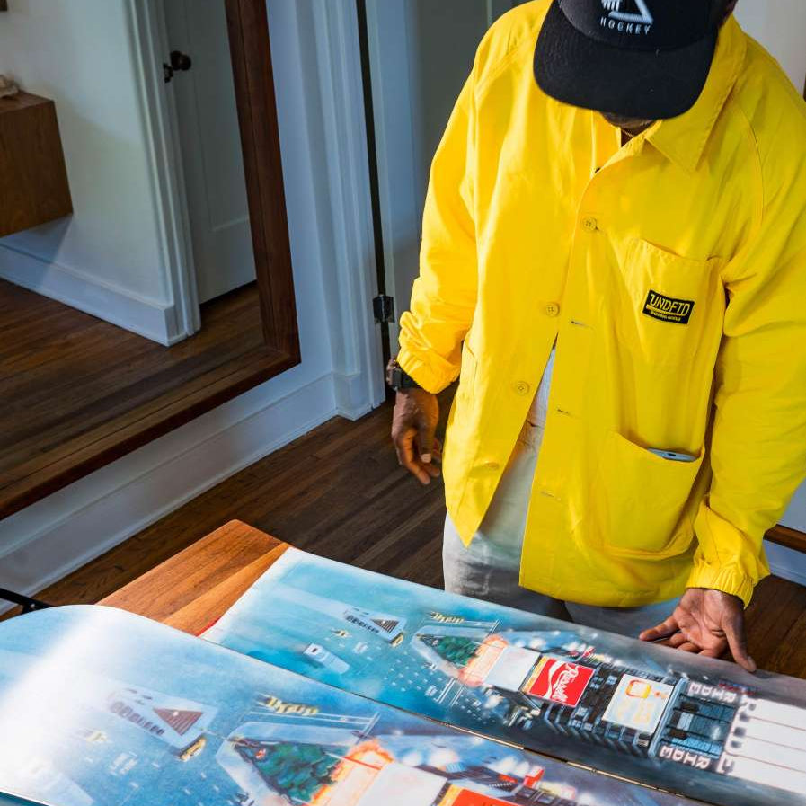 Ride Russell X Algoryhythm LTD Snowboard 2024 - A snowboard with a predominantly white base and blue accents, featuring a distinctive "Algorythym" logo on its top side.