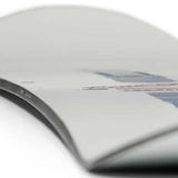 Rome Rene-Gade Snowboard 2024 - White snowboard with a black stripe down the middle and a red logo on top.