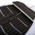 Ronix Flyweight Atlantik Wakesurf Board 2023 - A black and white wakesurf board with a textured surface, featuring a distinctive pattern of horizontal lines on its top side.