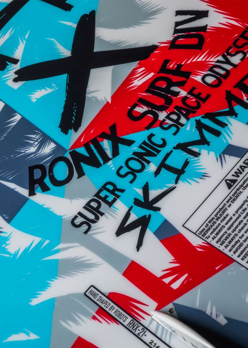 Ronix Kids Super Sonic Space Odyssey Skimmer Wakesurf Board 2022 - A blue and red wakesurf board with a white logo that says "Super Sonic" in stylized font.