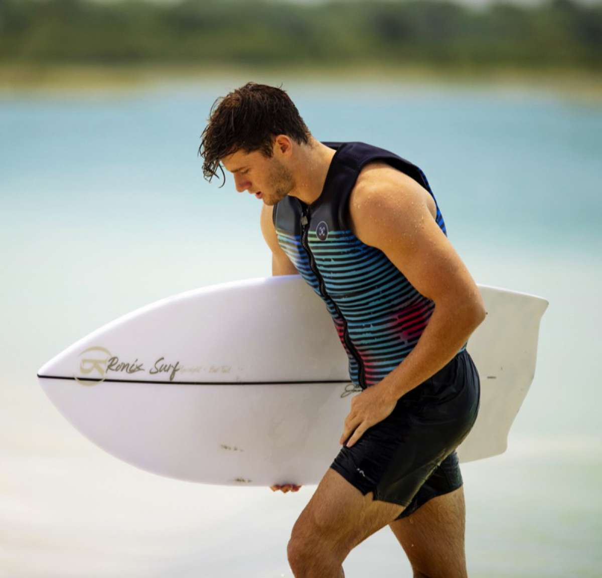 Ronix Party Impact Wake Vest 2022 - A black vest with a red and blue striped pattern on the front.