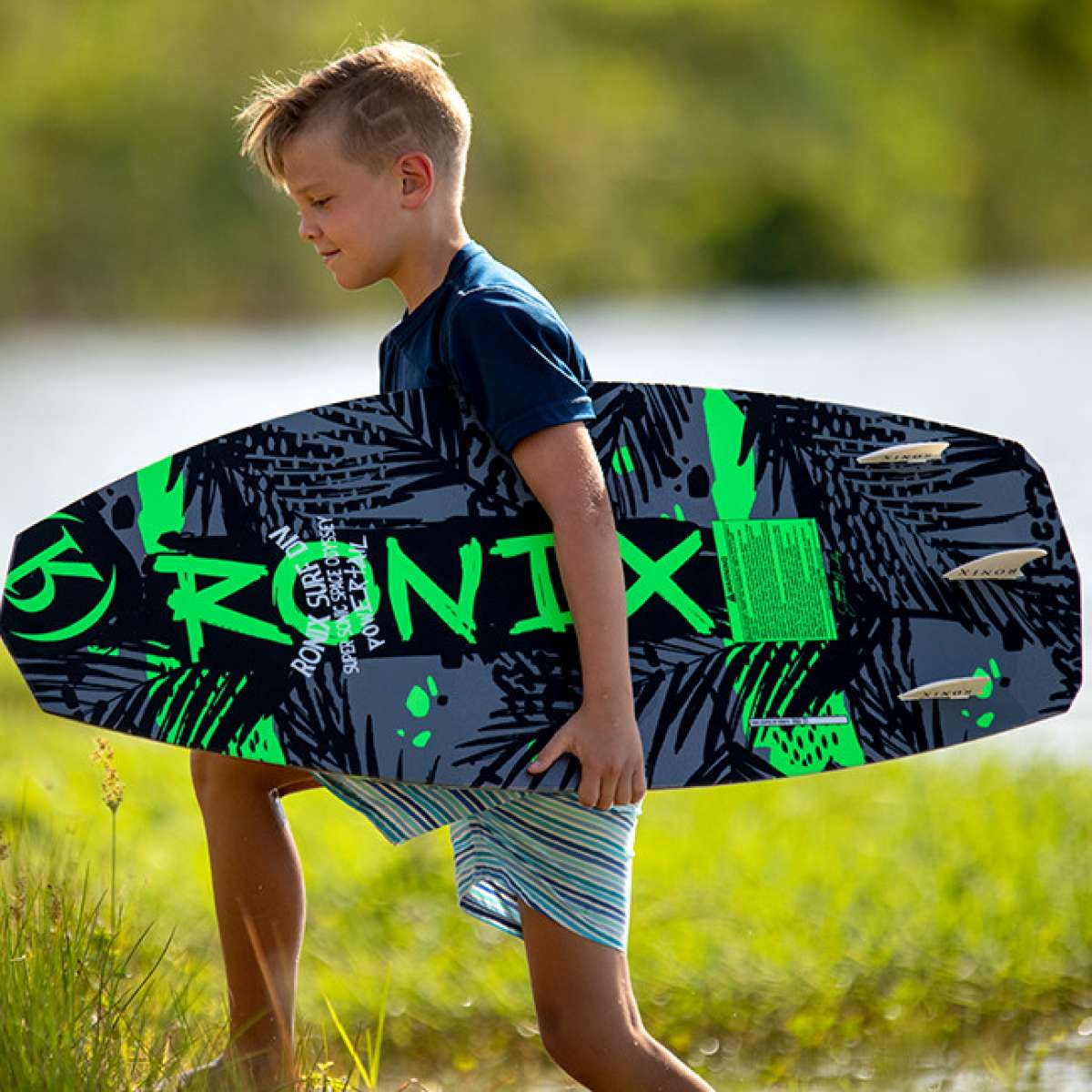 Ronix Super Sonic Space Odyssey Power Tail Wakesurf Board - A black wakesurf board with neon green accents and a space-themed design.