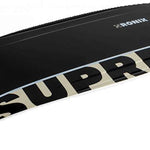 Ronix Supreme Air Core 3 Wakeboard 2023 - A black wakeboard with a white logo and text on top, featuring a tan-colored graphic along its bottom edge.