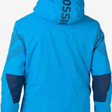 Rossignol All Speed Insulated Jacket 2022-2023 - A bright blue jacket with a hood, featuring black lettering on the back and a zippered pocket on the side.