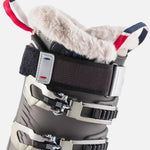 Rossignol Women's Pure Pro Heat 100 Ski Boots 2023 - Black ski boots with white fur lining and red, white, and blue straps.