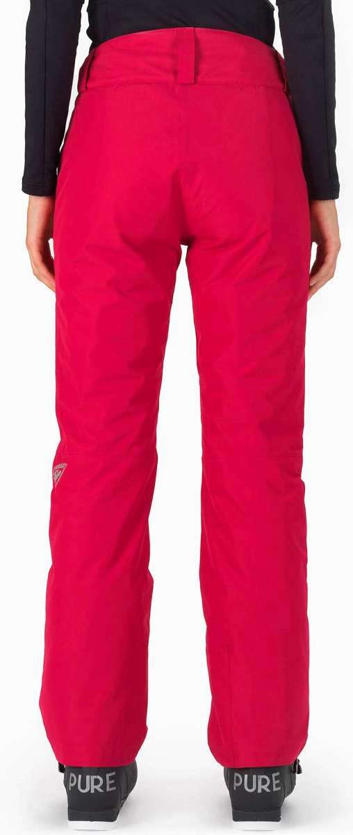 Rossignol Ladies Rapide Insulated Pant 2022-2023 - A pair of red ski pants with a white logo on the left leg, featuring a zippered pocket and adjustable cuffs.