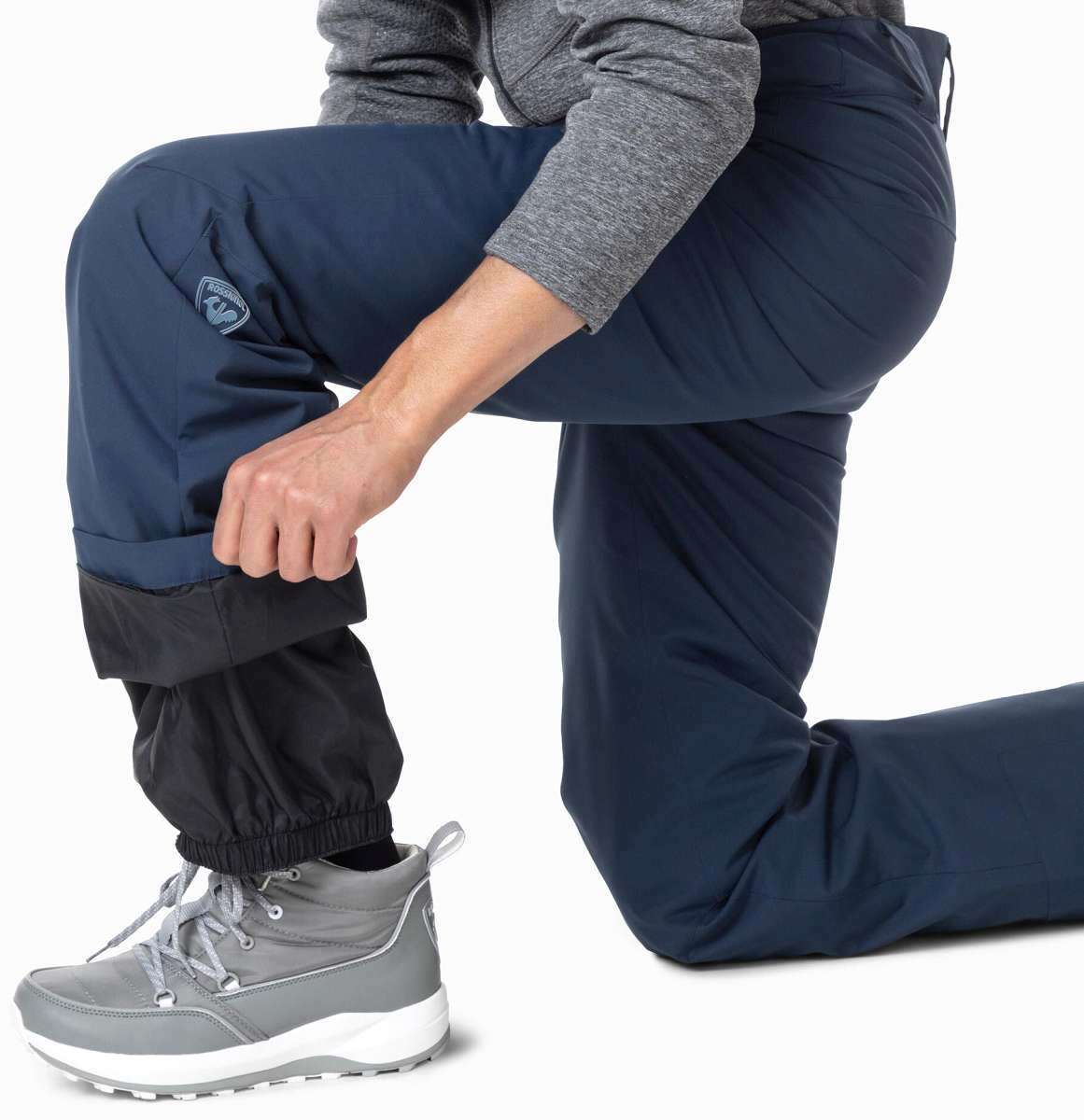 Rossignol Siz Insulated Pant 2024 - A pair of navy blue snow pants with a black waistband and leg cuffs, featuring a small logo on the left thigh.