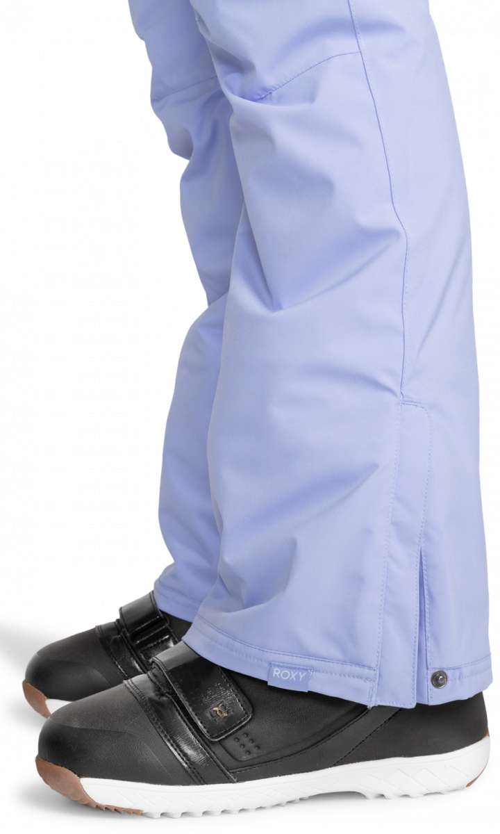 Roxy Junior's Backyard Insulated Pant 2024 - A pair of light blue snow pants with a small white logo on the left leg, featuring a zipper and snap button closure at the bottom.