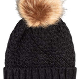 Roxy Junior's Blizzard Beanie 2024 - A black beanie with a large, fluffy tan-colored pom-pom on top.