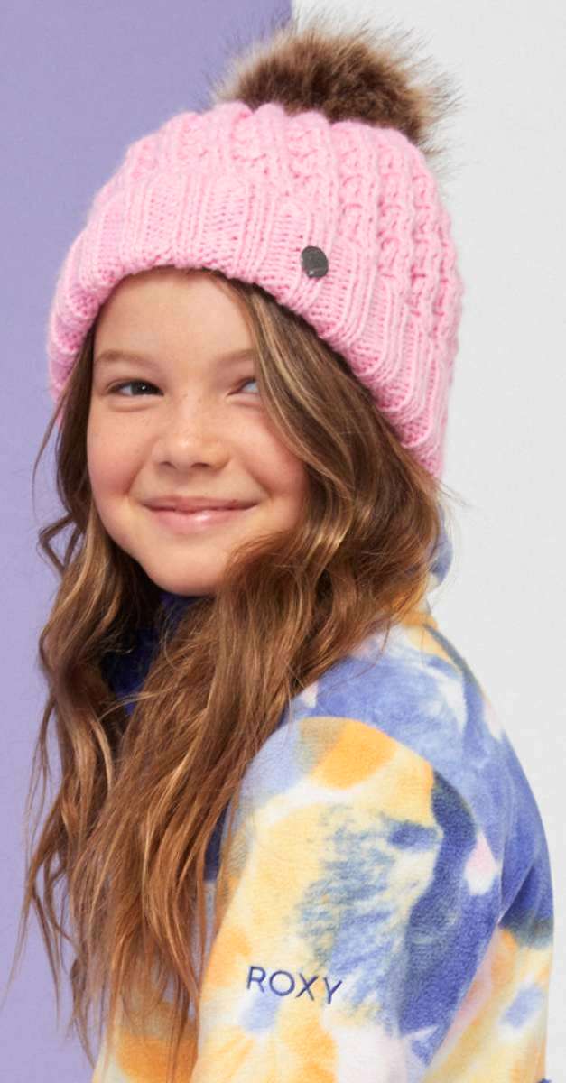 Roxy Junior's Blizzard Beanie 2024 - A pink beanie with a brown faux fur pom-pom on top.