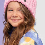 Roxy Junior's Blizzard Beanie 2024 - A pink beanie with a brown faux fur pom-pom on top.