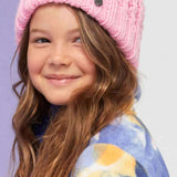 Roxy Junior's Blizzard Beanie 2024 - A pink beanie with a brown faux fur pom-pom on top.