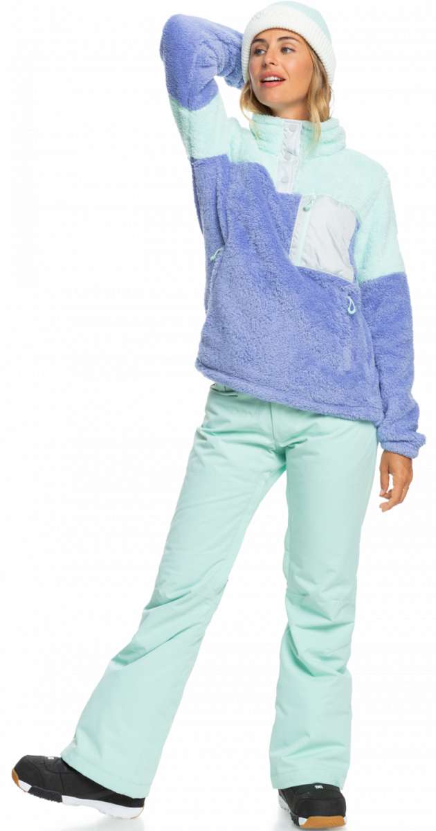Roxy Women's Alabama 1/4 Zip Fleece 2023 - A purple and mint green fleece zip-up sweater with a white zipper, worn by a model posing with her left arm raised.