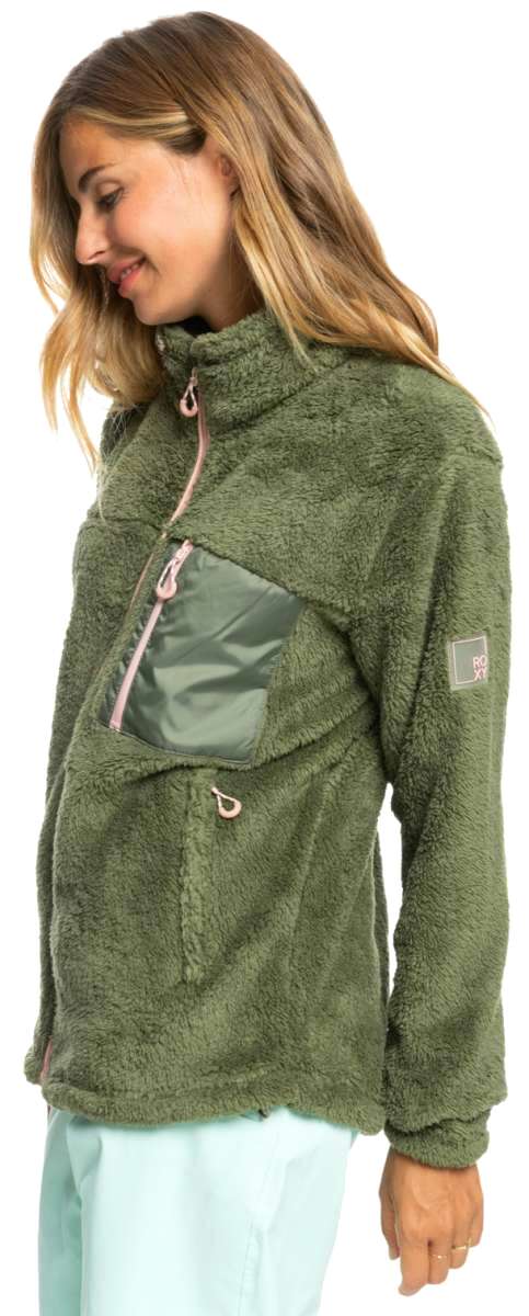 Roxy Women's Alabama Full Zip Jacket 2023 - A green fleece jacket with a zippered front and two pockets on either side, worn by a model in a studio setting.