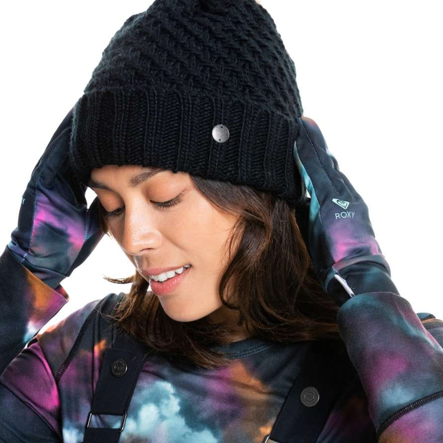 Roxy Women's Blizzard Beanie 2022 - A black knit beanie with a tan faux fur pom-pom on top.