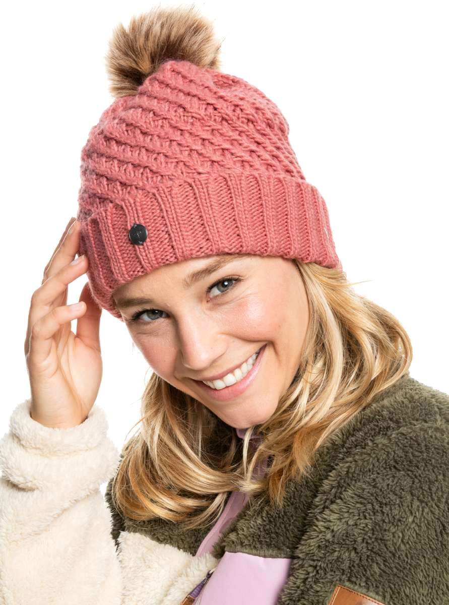 Roxy Women's Blizzard Beanie 2022 - A dusty rose-colored beanie with a ribbed pattern and a brown faux fur pom-pom on top.