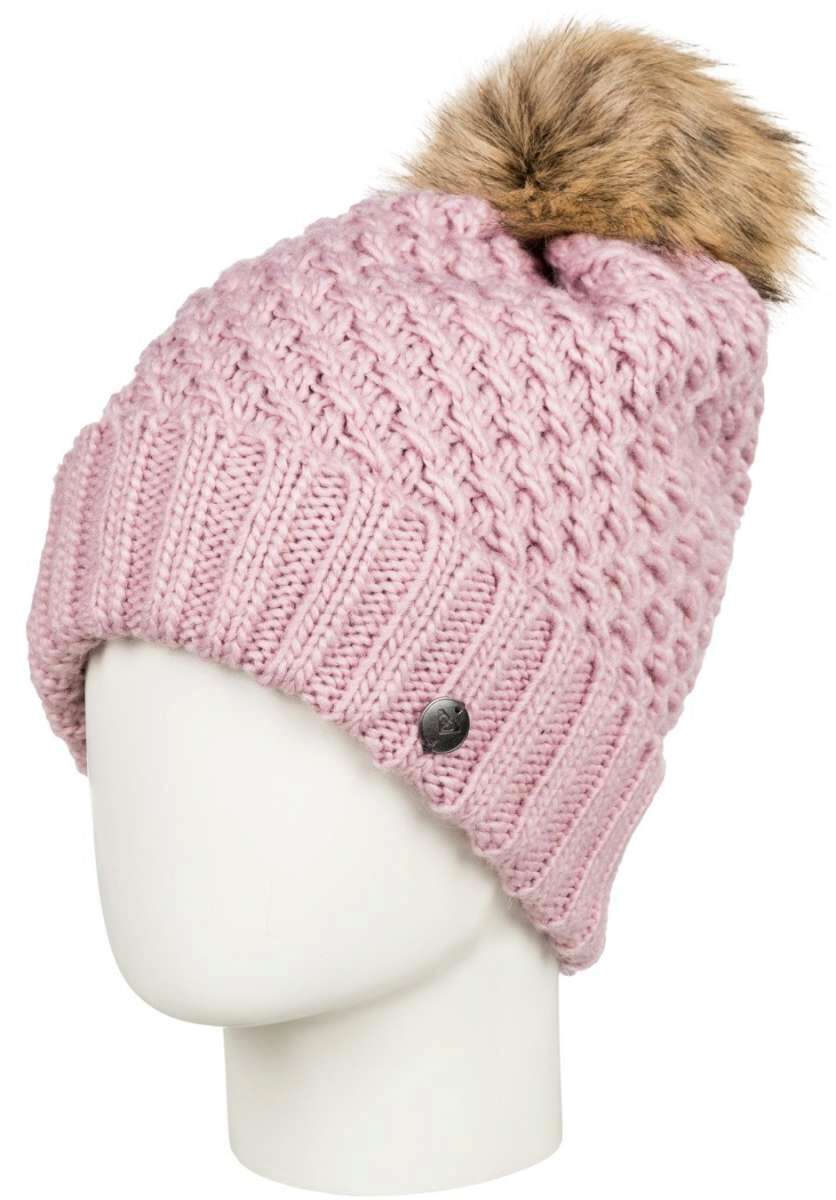 Roxy Women's Blizzard Beanie 2022 - A dusty rose-colored beanie with a cable-knit pattern and a brown faux fur pom-pom on top.