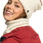 Roxy Women's Blizzard Beanie 2023 - A cream-colored beanie with a ribbed texture and a small brown faux-fur pom-pom on top.