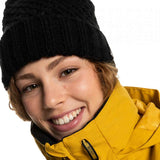 Roxy Women's Blizzard Beanie 2023 - A black knit beanie with a brown faux fur pom-pom on top.