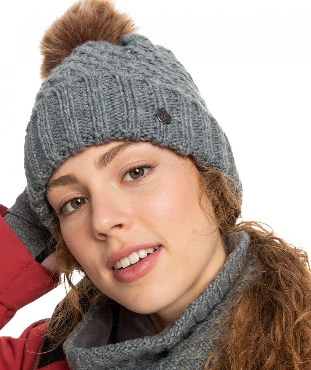 Roxy Women's Blizzard Beanie 2023 - A gray beanie with a brown faux fur pom-pom on top.