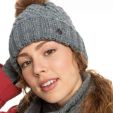 Roxy Women's Blizzard Beanie 2023 - A gray beanie with a brown faux fur pom-pom on top.
