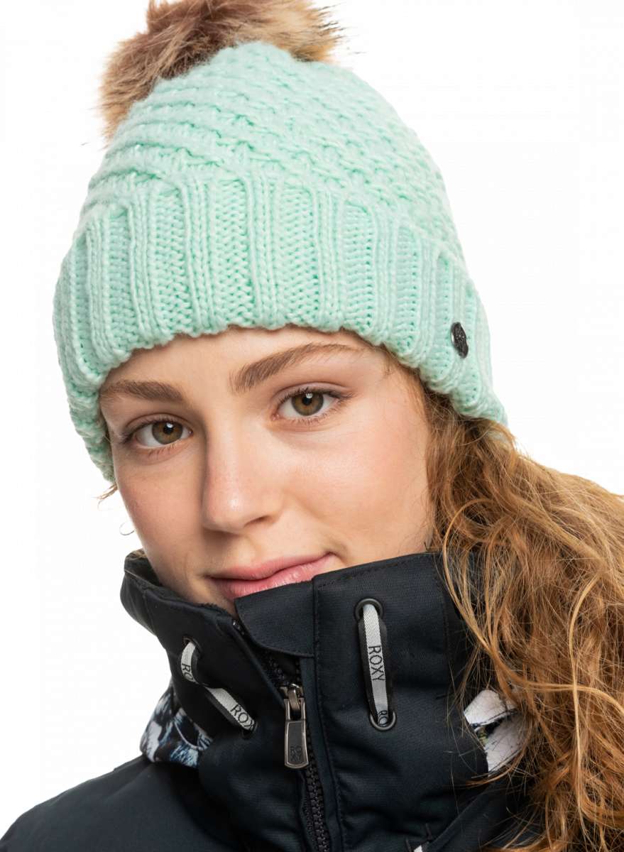 Roxy Women's Blizzard Beanie 2023 - A mint green beanie with a brown faux fur pom-pom on top.