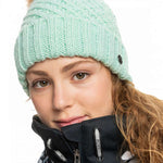 Roxy Women's Blizzard Beanie 2023 - A mint green beanie with a brown faux fur pom-pom on top.