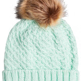 Roxy Women's Blizzard Beanie 2023 - A mint green beanie with a brown faux fur pom-pom on top.