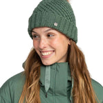 Roxy Women's Blizzard Beanie 2024 - A green beanie with a brown faux fur pom-pom on top.