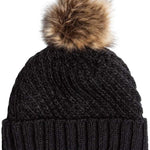 Roxy Women's Blizzard Beanie 2024 - A black beanie with a large, fluffy brown faux fur pom-pom on top.