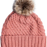 Roxy Women's Blizzard Beanie 2024 - A dusty rose-colored beanie with a cable-knit pattern and a large, fluffy brown faux fur pom-pom on top.