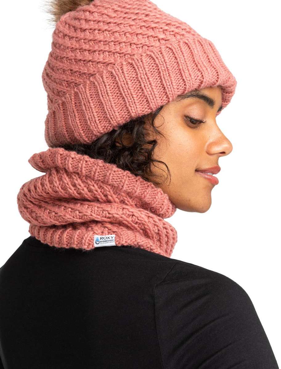Roxy Women's Blizzard Collar - A dusty rose-colored knit beanie with a faux fur pom-pom on top and a matching scarf wrapped around the neck.