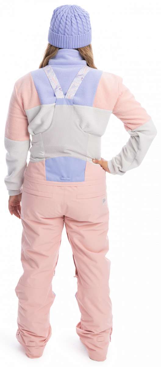 Roxy Women's Chloe Kim Bib Pant 2023 - Pastel pink snow pants with a subtle floral pattern on the straps and white accents around the waistband.