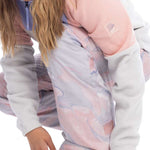 Roxy Women's Chloe Kim Insulated Pant 2023 - A pair of insulated snowboard pants with a marbled pattern in shades of pink and grey.