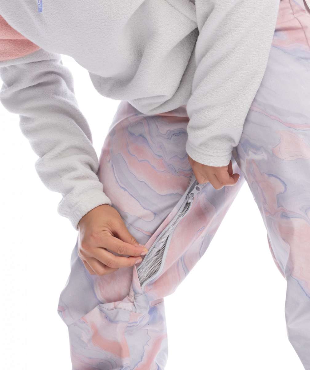 Roxy Women's Chloe Kim Insulated Pant 2023 - A pair of pink and grey snow pants with a marbled pattern, featuring a zipper on the left leg.