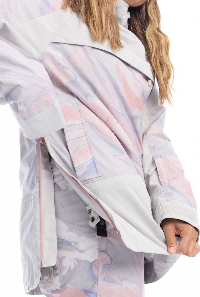 Roxy Women's Chloe Kim Overhead Jacket 2023 - A white jacket with a pink and blue marbled pattern, featuring a zippered pocket on the chest.