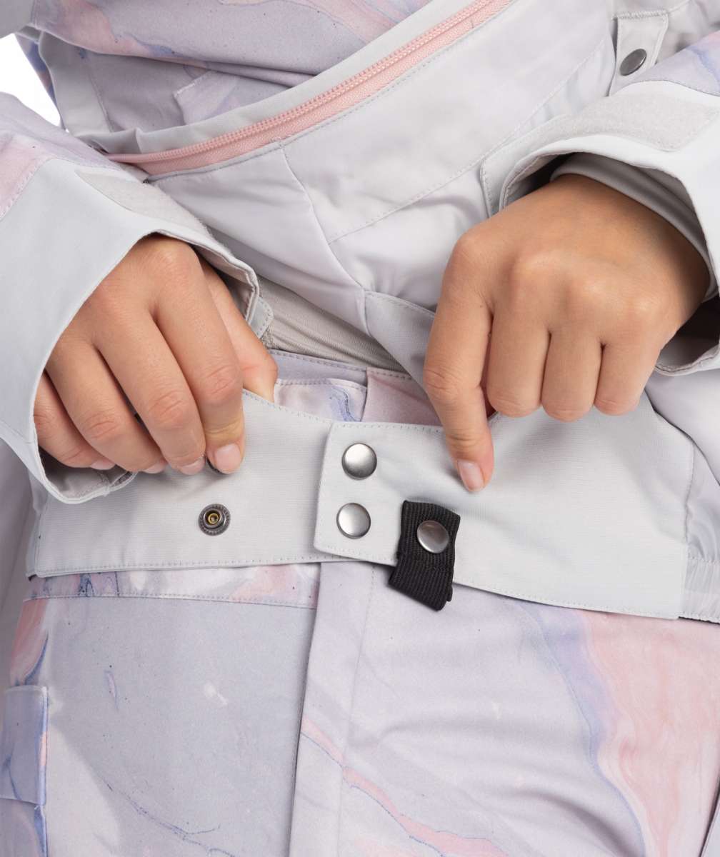 Roxy Women's Chloe Kim Overhead Jacket 2023 - A light gray jacket with a pink zipper and silver snap buttons.