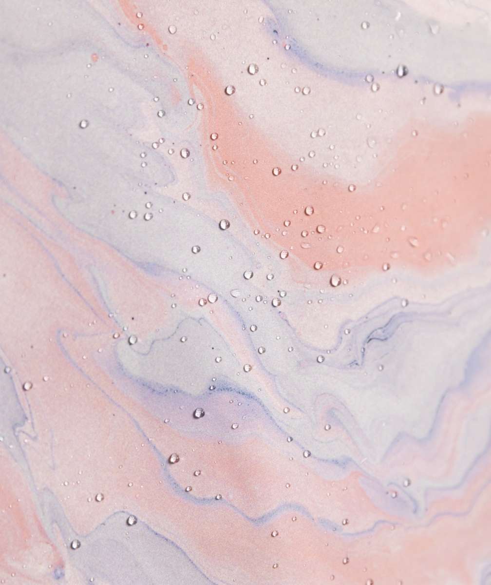 Roxy Women's Chloe Kim Overhead Jacket 2023 - A light blue jacket with a white snowflake pattern and black accents on the hood, collar, and zipper.