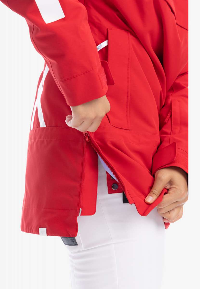 Roxy Women's Chloe Kim Overhead Jacket 2023 - A red jacket with a white stripe on the left sleeve and a zippered pocket on the right side.