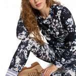 Roxy Women's Daybreak Bottom Base Layer 2023 - A black base layer with a white floral pattern and pink accents.