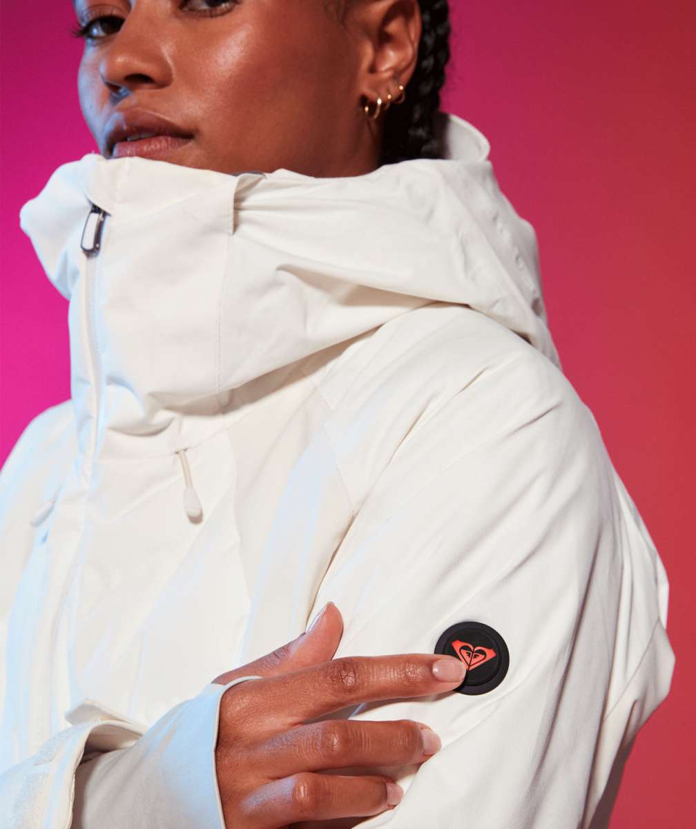 Roxy Women's Dusk Warmlink Insulated Jacket 2024 - A white jacket with a hood, featuring a black and red logo on the left sleeve.